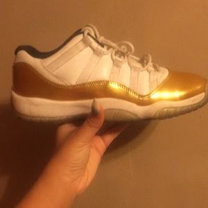 Gold and white Jordan 11s